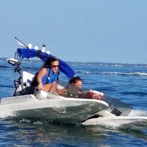 Man and son riding in boat on Mystic River
