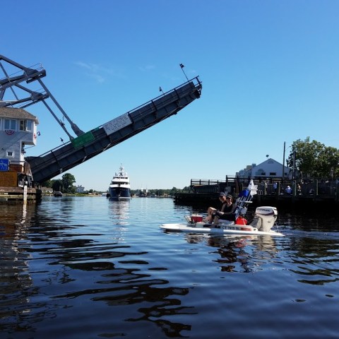 boats going under a bridge