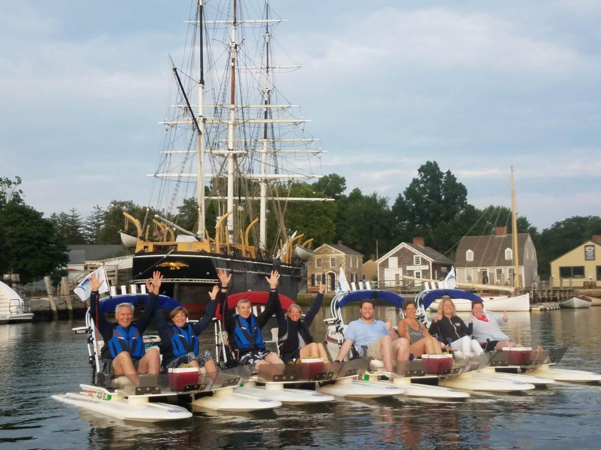 Group of boaters line up on the water to take a picture