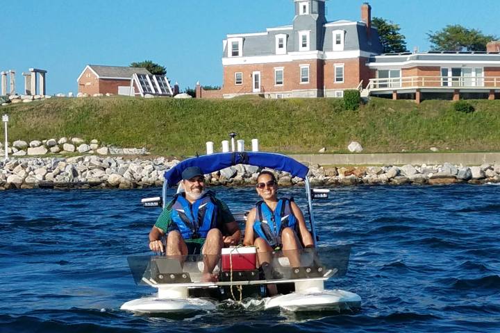 Couple in boat with lighthouse in the background