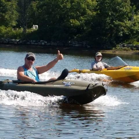 Two boaters driving individual boats on Mystic River
