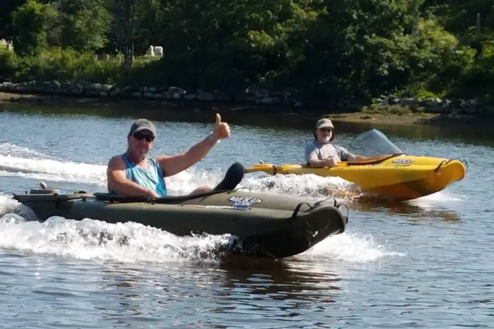 Two boaters driving individual boats on Mystic River
