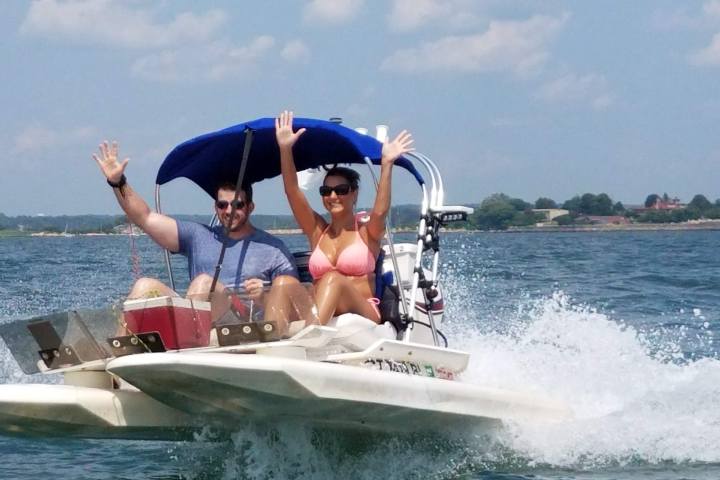 Two boaters with arms raised