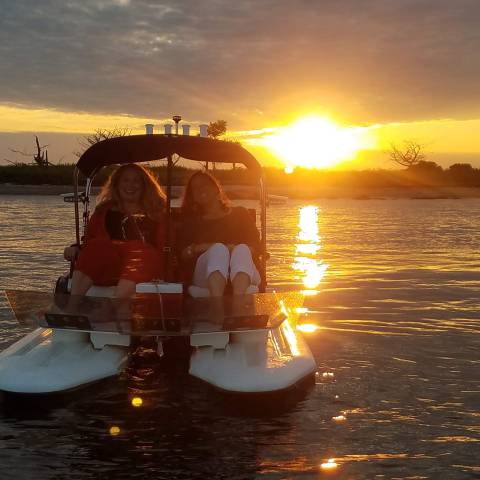a boat in the water at sunset