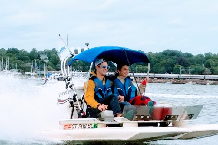 Two people riding on small boat