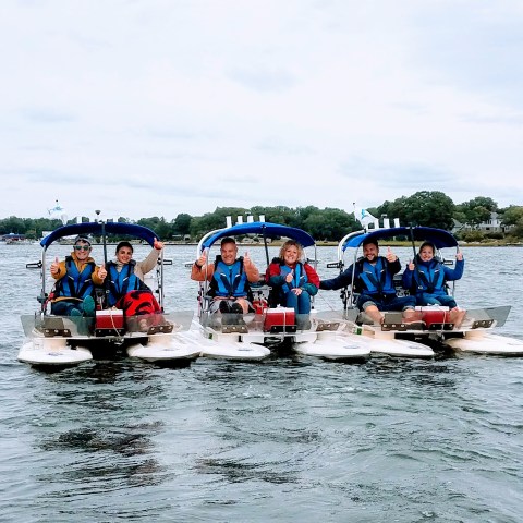 Group of boats with drivers lined up side by side