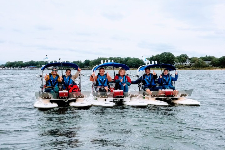 Group of boats with drivers lined up side by side